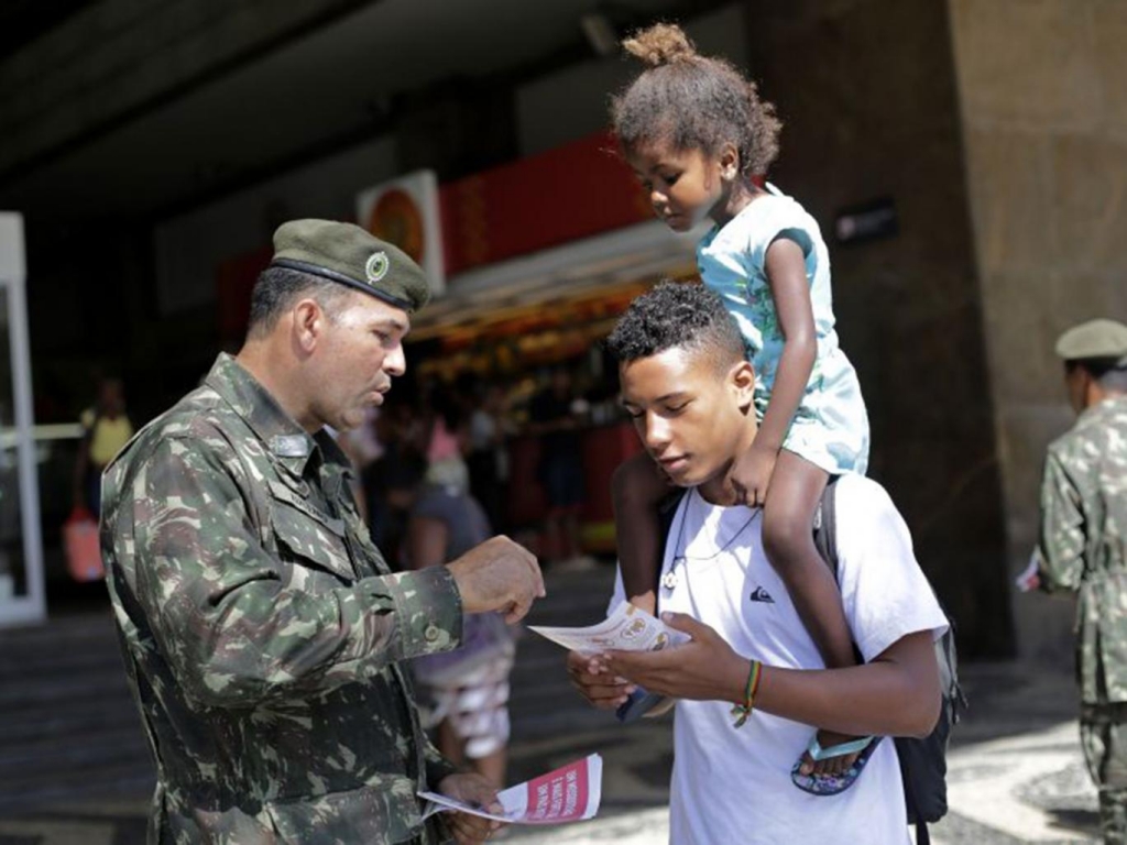 Members of the armed forces hand out leaflets on the Zika virus AP