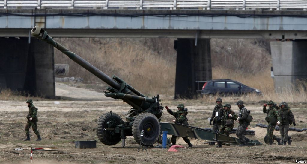 FILE- South Korean soldiers of an artillery unit take part in an artillery drill with 155mm Towed Howitzers in a previous year's Foal Eagle joint military exercise of the U.S. and South Korea near the demilitarized zone. In the wake of North K