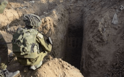 An Israel Defense Forces soldier overlooks at Hamas-built terror tunnel in Gaza in July 2014 during Operation Protective Edge. Credit Israel Defense Forces