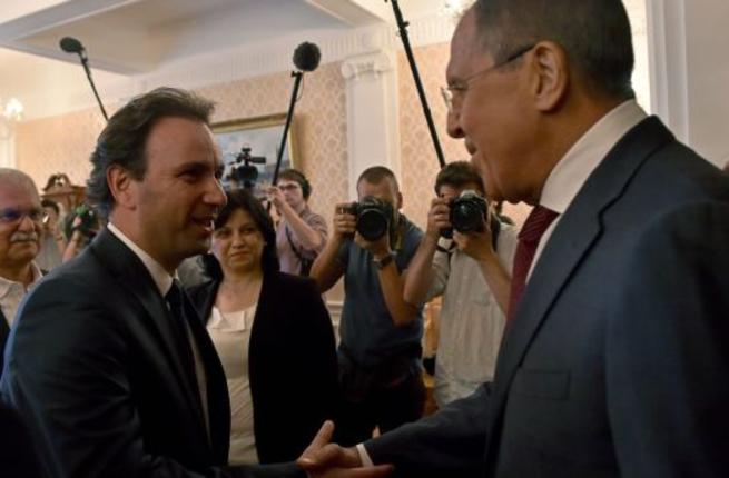 Russian Foreign Minister Sergei Lavrov welcomes Syrian Opposition Council President Khaled Khoja during their meeting in Moscow