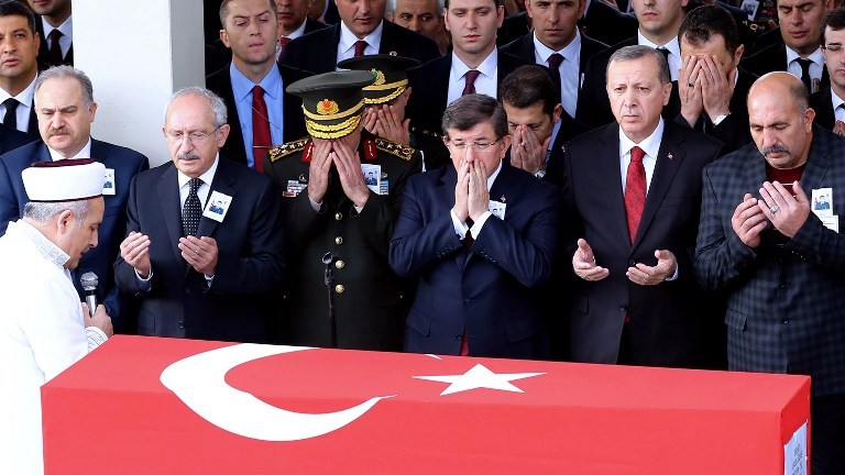 Turkey's President Recep Tayyip Erdogan pray during the funeral ceremony for an army officer in Ankara