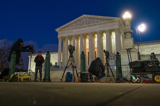 Television news crews set up in front of the U.S. Supreme Court building in Washington Saturday Feb. 13 2016. On Saturday the U.S. Marshals Service confirmed that Justice Antonin Scalia has died at the age of 79