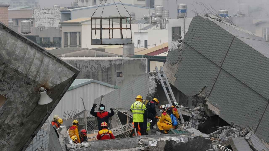 Rescue teams continue to search for the missing in a collapsed building after an early morning earthquake in Tainan Taiwan Saturday Feb. 6 2016