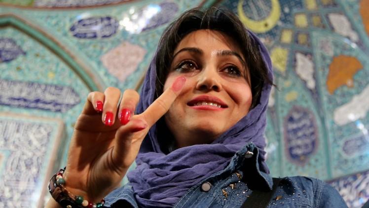 Atta Kenare  AFP  Getty Images An Iranian voter holds up an ink-stained finger after casting her ballot