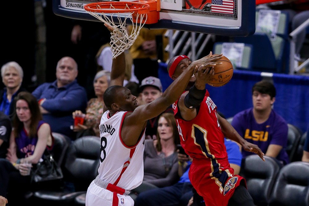 Toronto Raptors center Bismack Biyombo blocks the shot of New Orleans Pelicans forward Dante Cunningham during the NBA game between the Toronto Raptors and the New Orleans Pelicans at the Smoothie King Center in New Orleans LA