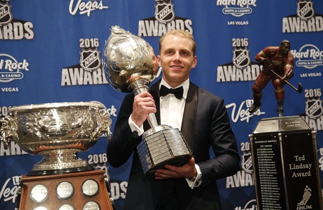 Chicago Blackhawks&#39 Patrick Kane poses with the Art Ross Trophy left the Hart Trophy center and the Ted Lindsay Award after winning the awards at the NHL Awards show Wednesday