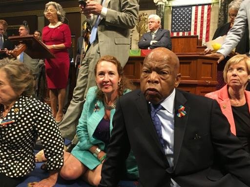 Chillie Pingree,D-Maine shows Democrat members of Congress including Rep. John Lewis D-Ga. center and Rep. Elizabeth Esty D-Conn. as they participate in sit-down protest seeking a a vote on gun control measures Wednesday