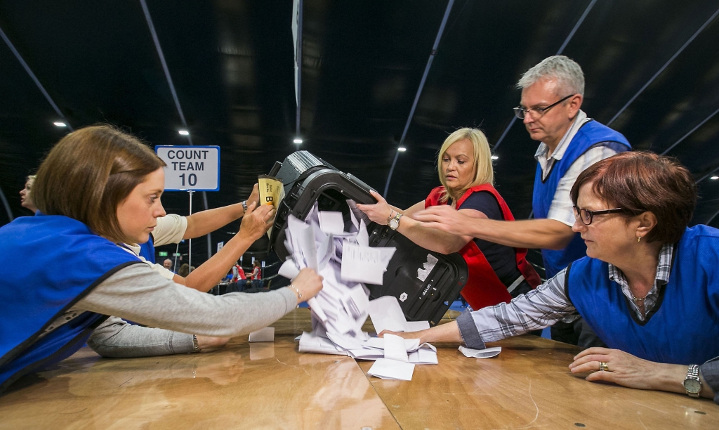 Counters tally ballot papers at the Titanic Exhibition Centre in Belfast Northern Ireland as counting got underway in the referendum on the UK membership of the European Union