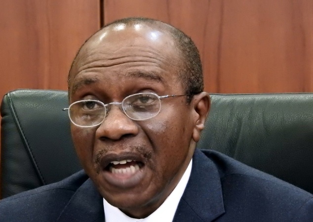 Central Bank of Nigeria's governor Godwin Emefiele gives a press conference on the naira devaluation during a media briefing in Abuja