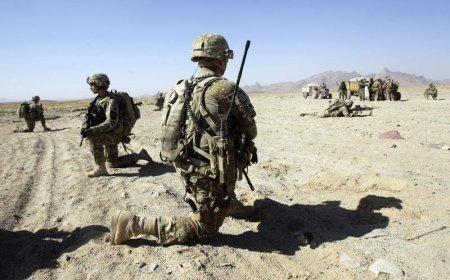 U.S. Army soldiers of 2nd Battalion 1st Infantry Regiment take up positions while Afghan soldiers search motorists during a joint U.S.-Afghan military patrol in a village in Arghandab Valley in Kandahar province southern Afghanistan