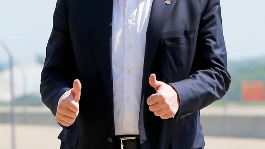 Republican presidential candidate Donald Trump gives a thumbs up as he arrives for a campaign rally Saturday