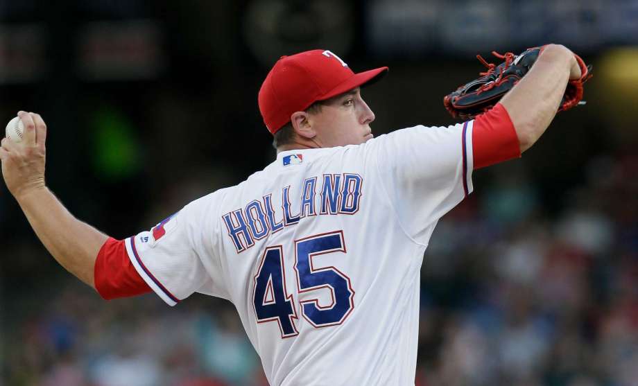 Texas Rangers starting pitcher Derek Holland throws during the first inning of a baseball game against the Baltimore Orioles in Arlington Texas Monday