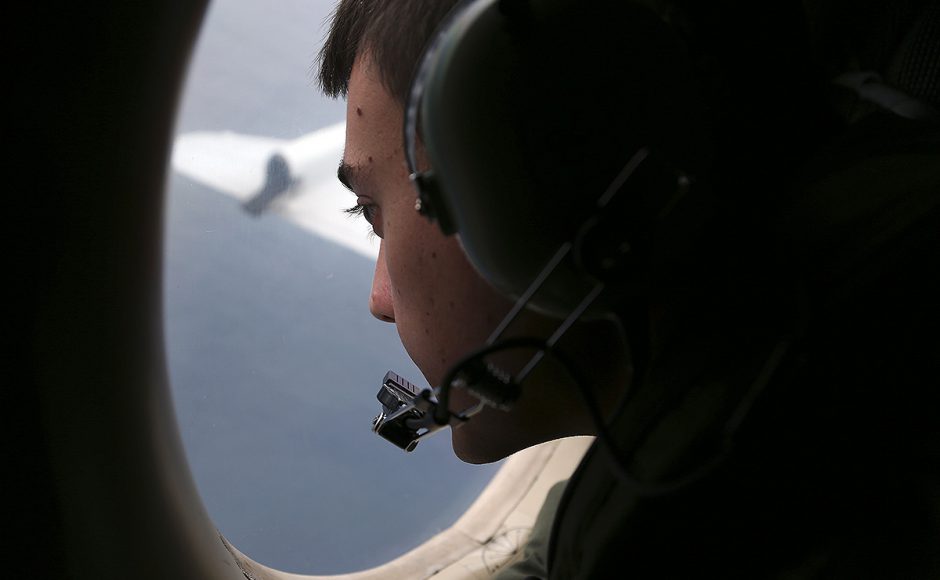 A pilot scours the search area for flight MH370 from the air. Pic AP