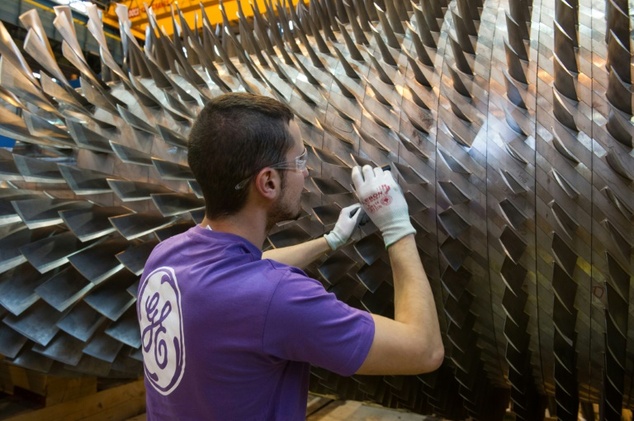 An employee of US multinational General Electric works on a gas turbine at the GE plant in Belfort France in 2015