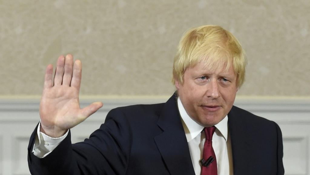 Boris Johnson waves as he finishes delivering his speech in London Britain