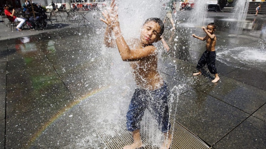 Brothers Mohammed 10 left and Yousef Othman 3 play in the fountains at Yonge Dundas Square