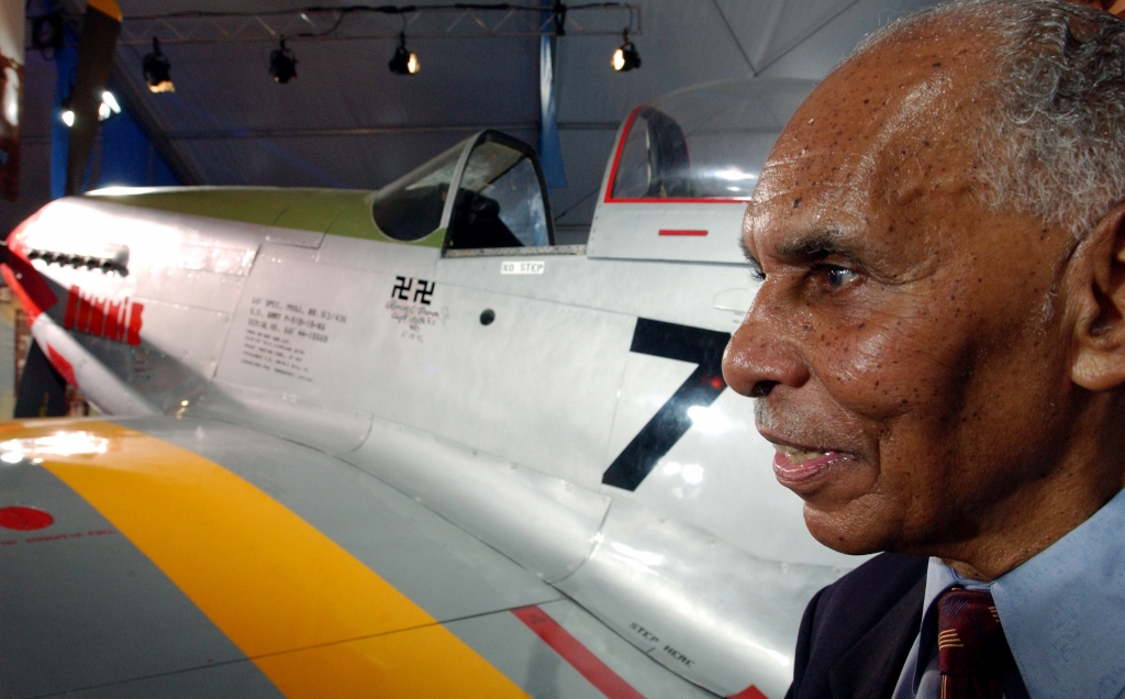 Captain Roscoe C. Brown stands next to the actual P-51 Mustang he flew as a member of the Tuskegee Airmen during World War II