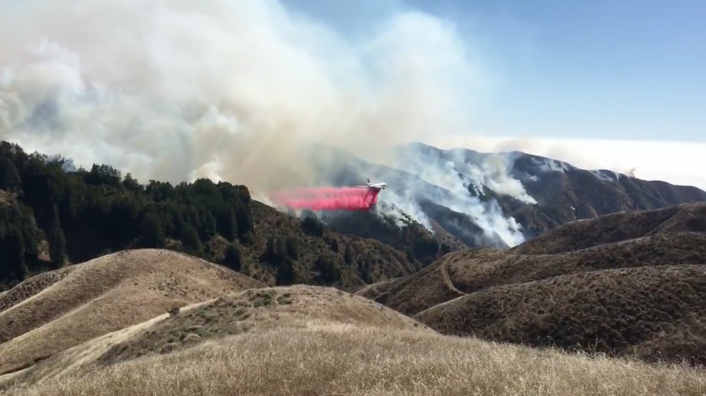 Fire retardant is dropped from a tanker to help stop the spread of Monterey County's Soberanes Fire