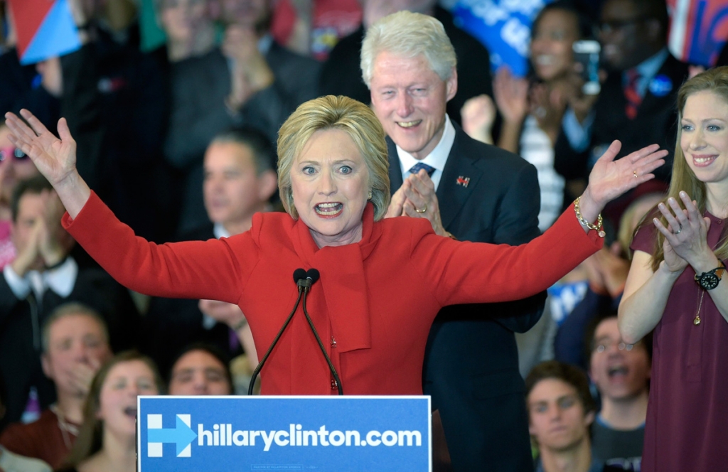 Hillary Clinton speaks as her husband Bill and her daughter Chelsea look on. EPA  Craig Lassig