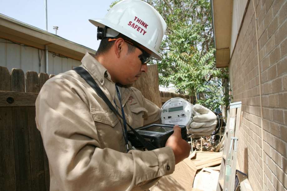 An Oncor worker installs a meter.&nbsp