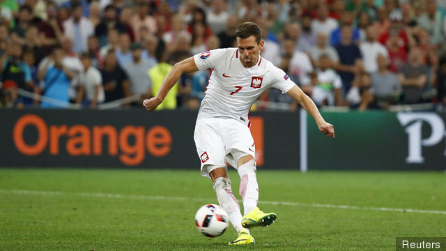 Poland's Arkadiusz Milik scores during the penalty shootout