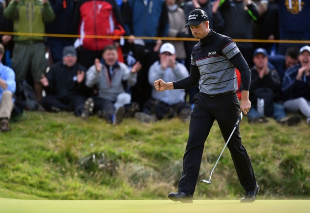 Sweden's Henrik Stenson reacts after making a birdie putt