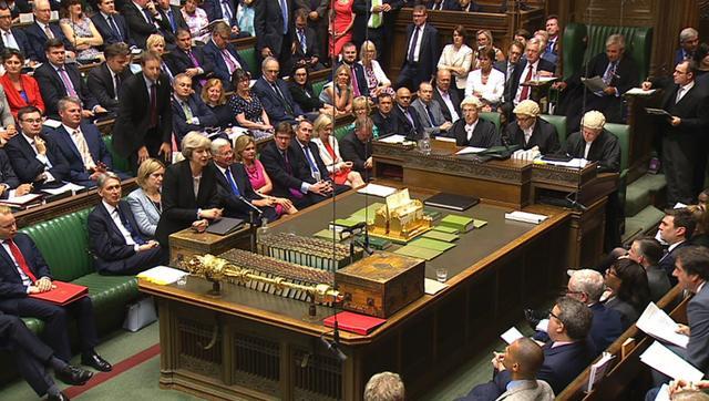 British Prime Minister Theresa May speaks at the dispatch box during Prime Minister’s Questions in the House of Commons on Wednesday