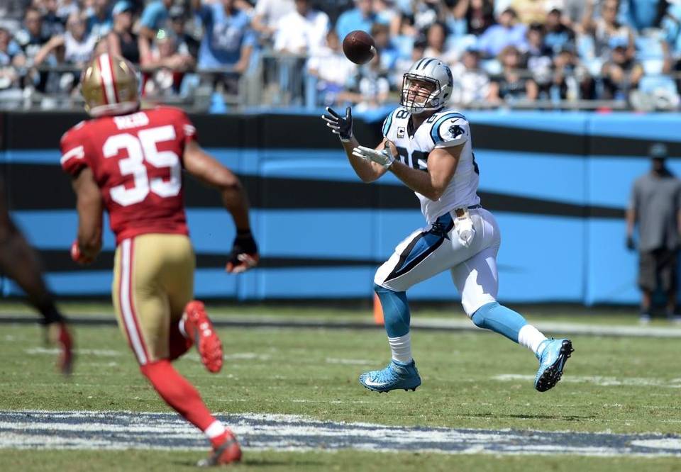 Carolina Panthers tight end Greg Olsen reaches up for the ball as he heads to the end zone