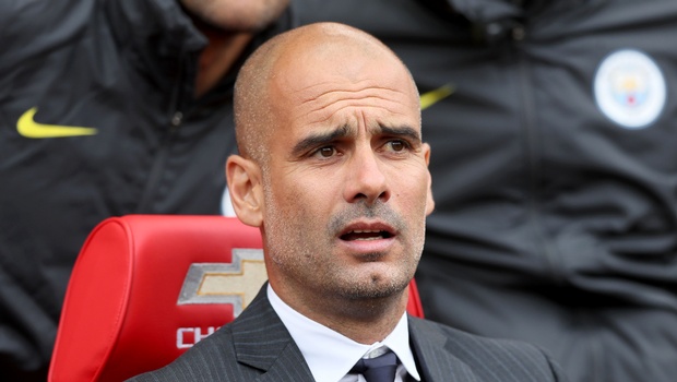 Manchester City manager Pep Guardiola takes his seat in the dugout before the English Premier League soccer match between Manchester United and Manchester City at Old Trafford Manchester England Saturday Sept. 10 2016. | AP