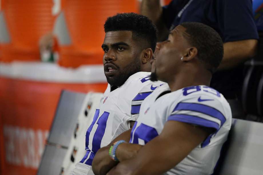 Ezekiel Elliott of the Dallas Cowboys talks to Terrance Williams on the sidelines during a preseason game against the Houston Texans at AT&T Stadium on Sept. 1 2016 in Arlington