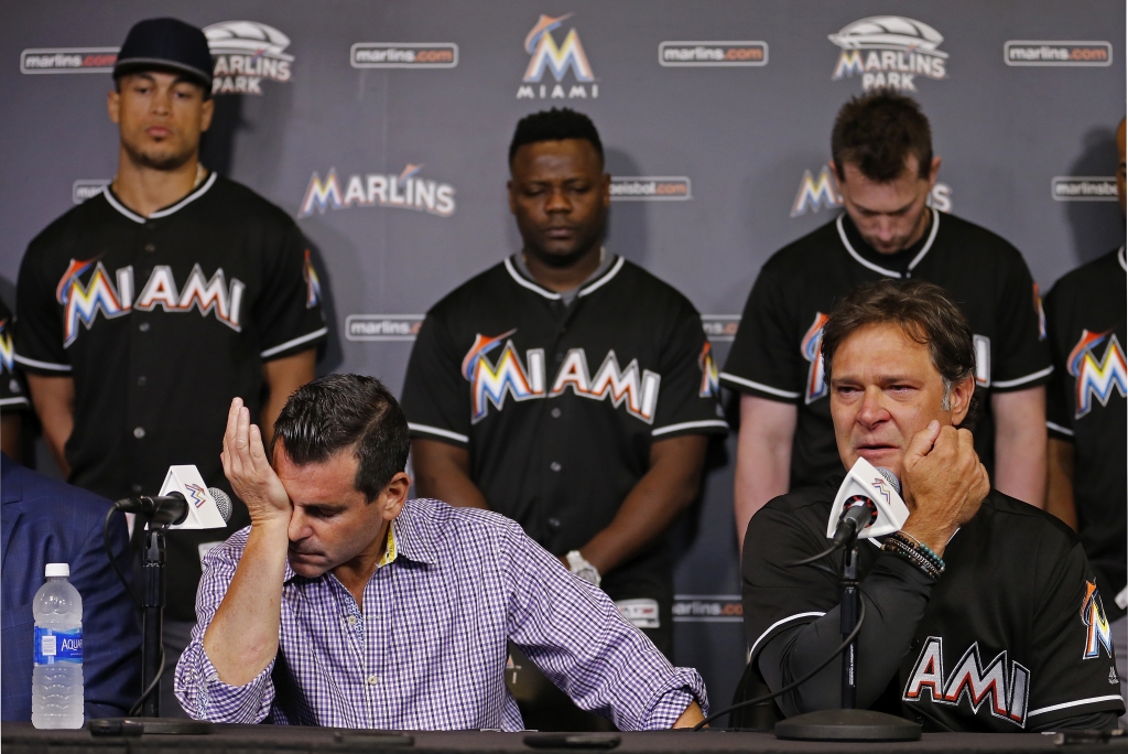 Miami Marlins team president David Samson front left manager Don Mattingly and players behind from left Giancarlo Stanton Fernando Rodney and Chris Johnson react during a press conference after pitcher Jose Fernanedez died in a boating accident. P