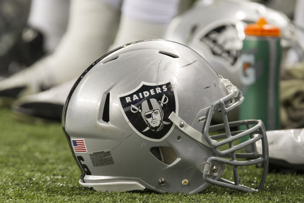 22 NOVEMBER 2015 A Oakland Raiders helmet sits on the turf at the feet of the players during game action between the Oakland Raiders and the Detroit Lions during a regular season game played at Ford Field in Detroit Michigan