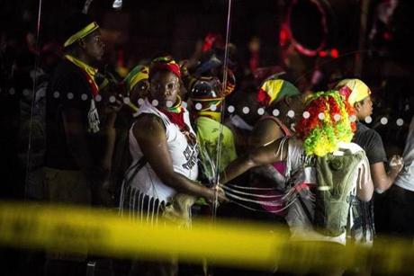 Revelers walked past the scene of a shooting near Empire Boulevard and Flatbush Avenue during the J’ouvert celebration in New York early Monday morning