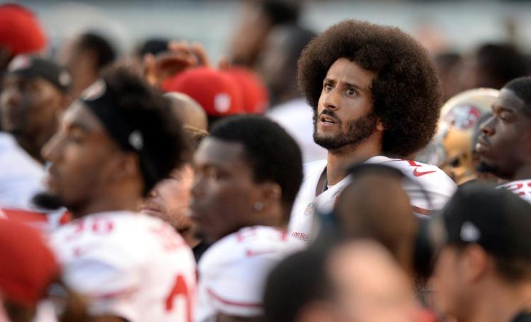 Niners quarterback Colin Kaepernick protests and gets the starting job