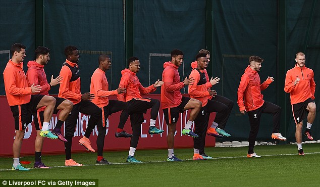 The Liverpool squad carry out some dynamic stretches at the start of training on Wednesday