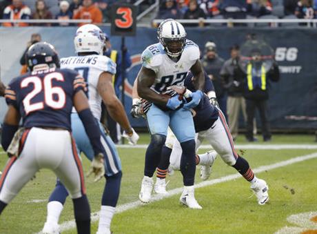 Tennessee Titans tight end Delanie Walker runs to the end zone for touchdown against Chicago Bears inside linebacker Danny Trevathan during the first half of an NFL football game Sunday Nov. 27 2016 in Chicago. (AP