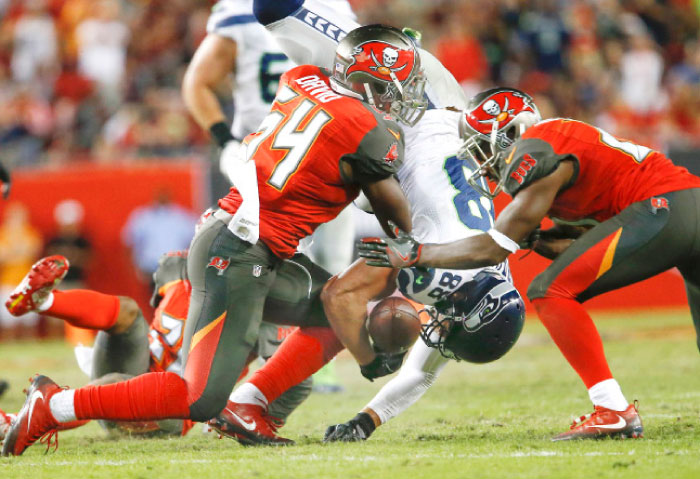 Tampa Bay Buccaneers’ outside linebacker Lavonte David and cornerback Alterraun Verner combine on the hit against Seattle Seahawks’ tight end Jimmy Graham to fumble the ball during the second half of their NFL game at Raymon