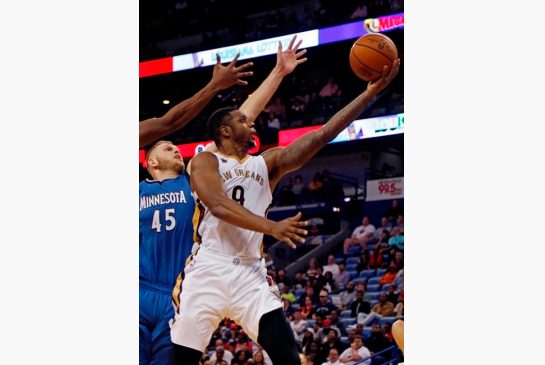 New Orleans Pelicans forward Terrence Jones right makes a layup against Minnesota Timberwolves center Cole Aldrich left during the second half of an NBA basketball game in New Orleans Wednesday Nov. 23 2016. The Pelicans won 117-96. (AP