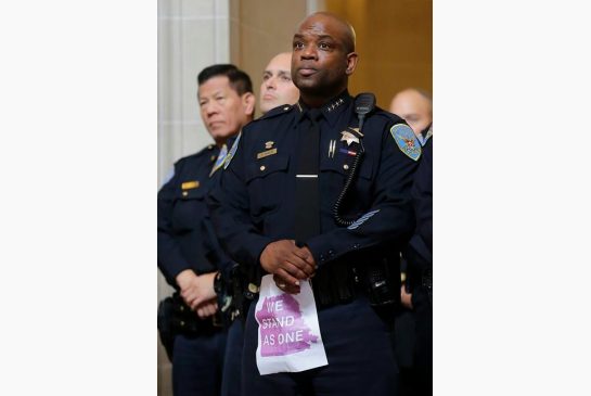 Acting San Francisco Police Chief Toney Chaplin listens to speakers during a meeting at City Hall in San Francisco by city leaders and community activists to reaffirm the city's commitment to being a sanctuary city in response to Donald Trump's support