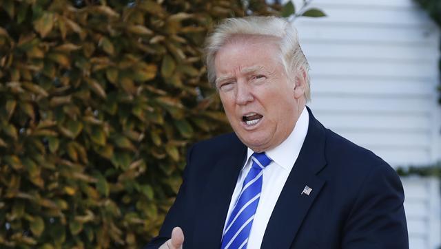 President-elect Donald Trump gives the thumbs-up as he arrive at the Trump National Golf Club Bedminster clubhouse in Bedminster