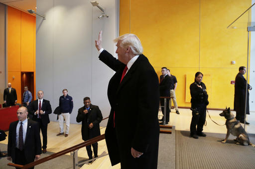 President-elect Donald Trump waves to a crowd in the lobby of the New York Times building following a meeting Tuesday Nov. 22 2016 in New York