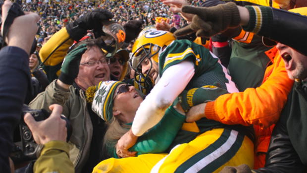 After scoring a touchdown Packers quarterback Aaron Rodgers celebrates with the Packers fans