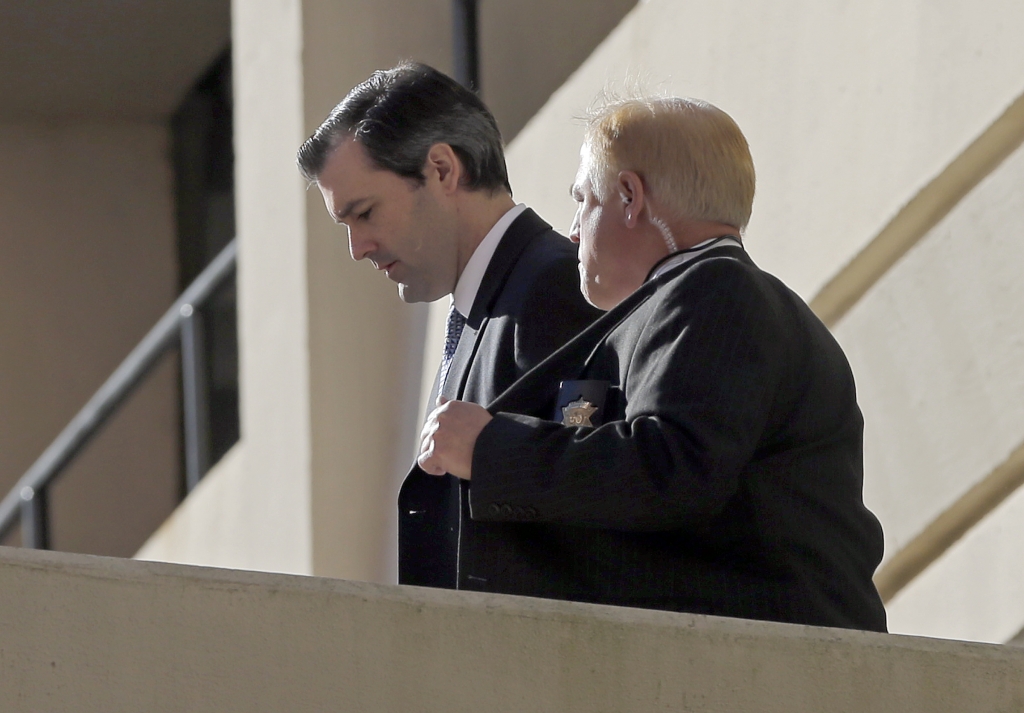 Former North Charleston police officer Michael Slager left is escorted from the courthouse during his murder trial at the Charleston County court in Charleston S.C. Friday Dec. 2 2016. The case of a former South Carolina police officer charged with