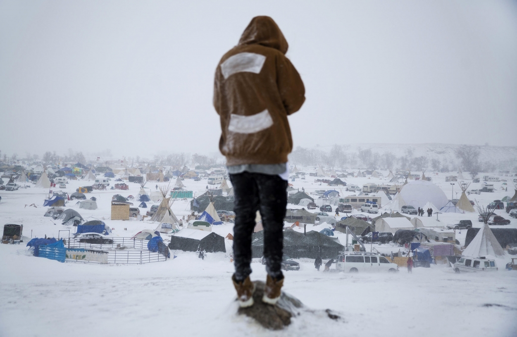 Damin Radford of New Zealand overlooks the Oceti Sakowin camp on Tuesday where people have gathered to protest the Dakota Access pipeline near Cannon Ball N.D