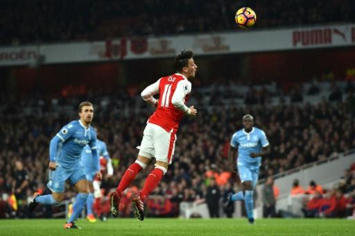 Ozil proves worth as Arsenal go top