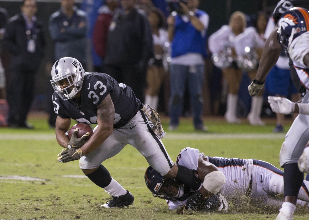 Nov 6 2016 Oakland CA USA Oakland Raiders running back De Andre Washington is tackled by Denver Broncos inside linebacker Corey Nelson during the fourth quarter at Oakland Coliseum. Mandatory Credit Neville E. Guard-USA TODAY Sports