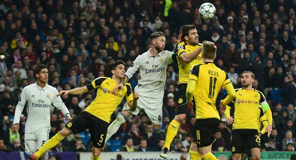 Real Madrid’s Sergio Ramos vies with Sokratis at the Santiago Bernabeu stadium