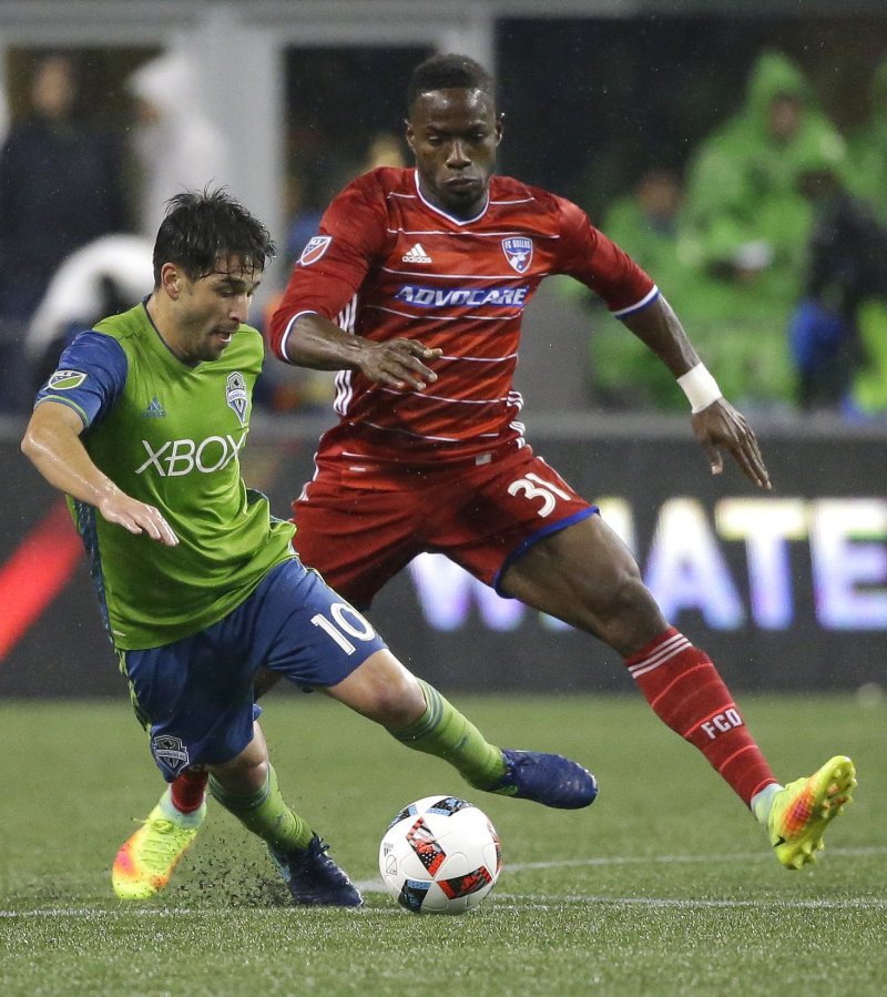 Seattle midfielder Nicolas Lodeiro keeps the ball away from FC Dallas Maynor Figueroa during a playoff match. Lodeiro's midseason arrival sparked the Sounders run to MLS Cup