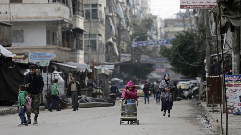 Syrian girl pushes a cart loaded with cooking gas canisters in Aleppo Syria. A rebel defeat in Aleppo Syria’s largest city and former commercial center is likely to reverberate across the war-torn country where