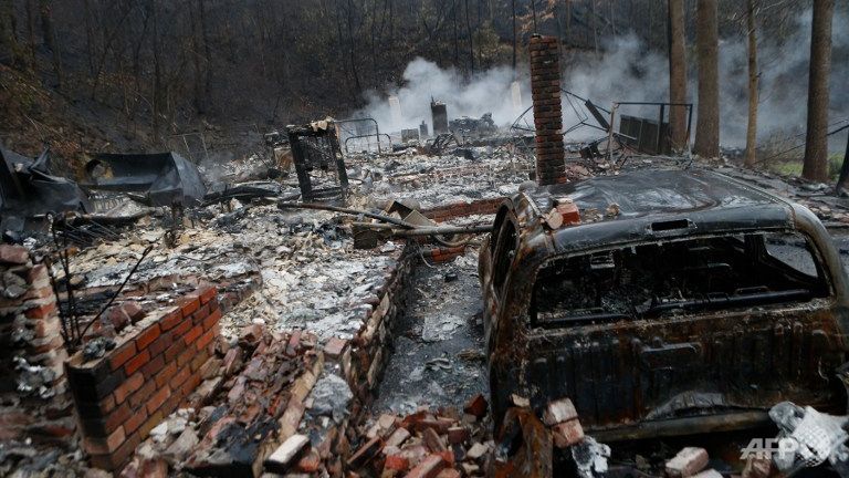 The remains of a home smolder in the wake of a wildfire Nov 30 2016 in Gatlinburg Tennessee